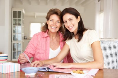 Adult mother and daughter scrapbooking